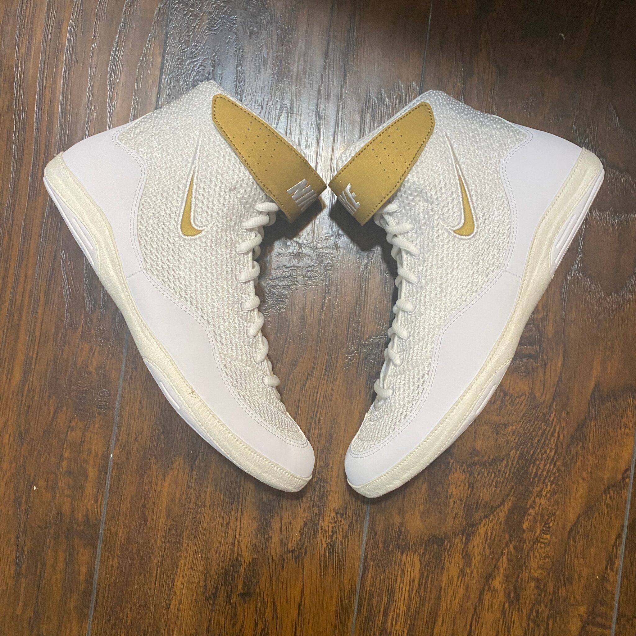 white and gold nike inflicts